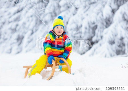 Boy on sled ride. Child sledding. Kid on sledge Boy on sled ride. Child sledding. Kid on sledge 109598331