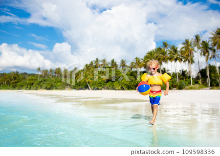 Kids play on tropical beach. Sand and water toy. Kids play on tropical beach. Sand and water toy. 109598336