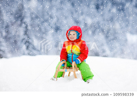 Boy on sled ride. Child sledding. Kid on sledge Boy on sled ride. Child sledding. Kid on sledge 109598339