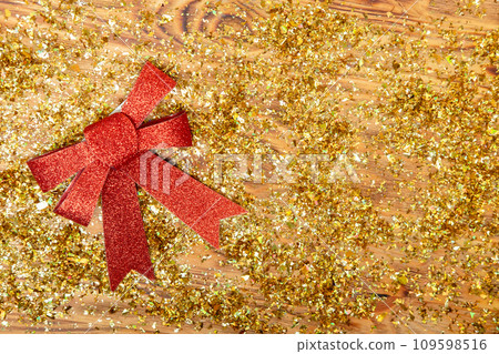 red New Year's bow on a golden shiny background, copy space 109598516
