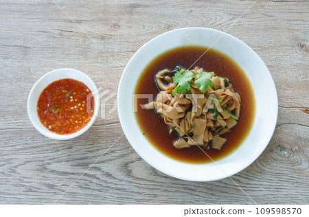 stewed duck intestine in brown soy soup on plate dipping spicy sauce stewed duck intestine in brown soy soup on plate dipping spicy sauce 109598570