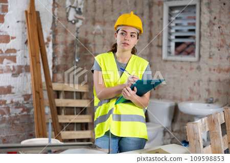 Woman engineer checking documents during repair works Woman engineer checking documents during repair works 109598853