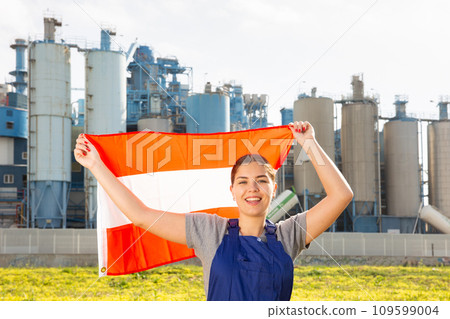 Smiling young woman near factory with flag of Austria Smiling young woman near factory with flag of Austria 109599004