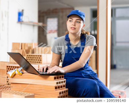 Woman with laptop on indoor construction site 109599140
