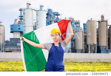 Serious young woman near factory with Italy flag 109599471