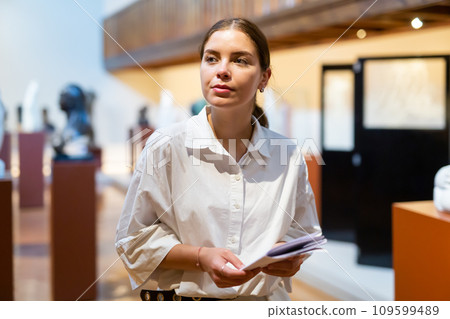 Woman visiting sculpture hall in historical museum 109599489