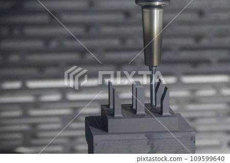 The CNC milling machine cutting the graphite electrode parts. The CNC milling machine cutting the graphite electrode parts. 109599640