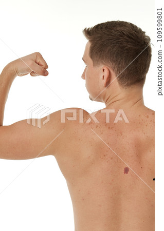 young man showing his bicep over white background. Rear view 109599801