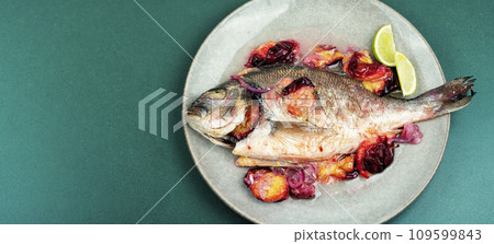 Dorado fish baked on a white plate. Dorado fish baked on a white plate. 109599843