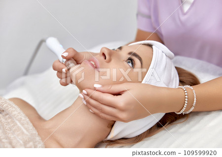 beautiful woman getting microdermabrasion procedure in a beauty spa salon 109599920