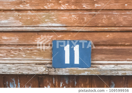 Symbol sign number 11 eleven house object close-up home macro soft focus on wooden background Symbol sign number 11 eleven house object close-up home macro soft focus on wooden background 109599936