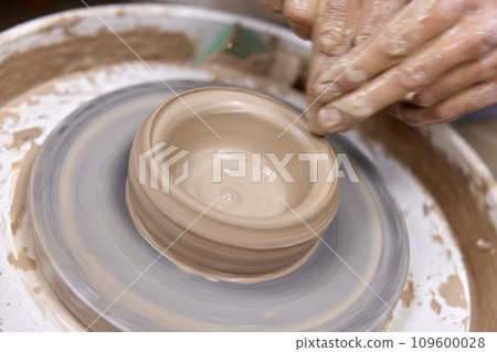 male hands making ceramic cup on pottery wheel, Close-up male hands making ceramic cup on pottery wheel, Close-up 109600028
