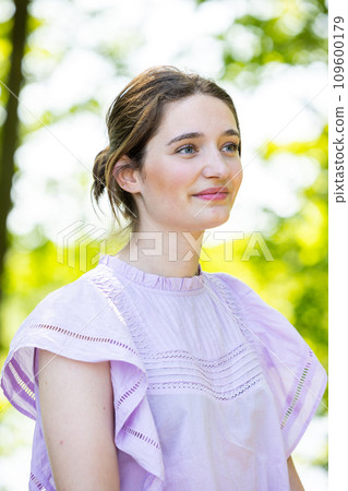 Contemplative Elegance: Young Woman in a Lavender Blouse 109600179