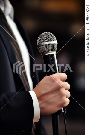 Man in Suit Gripping Microphone Man in Suit Gripping Microphone 109600281