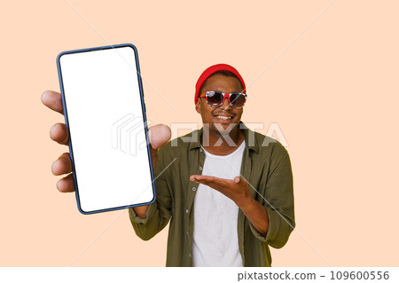 Happy Smiling Confident Man Points On White Display Screen On Mobile Phone Isolated On Pink. Internet Apps, Mobile Advertising Concept. High Quality Photo  109600556