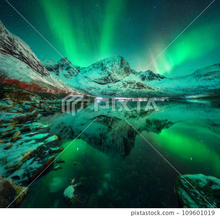 Northern lights, snowy mountains, reflection in water at night 109601019