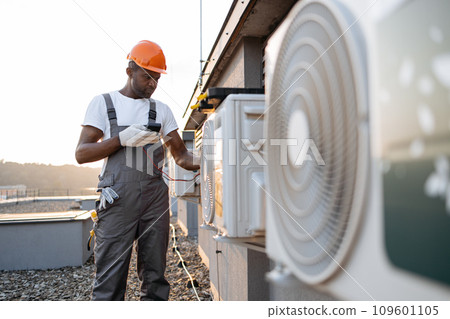 Man using tester for measuring strength in air conditioner 109601105