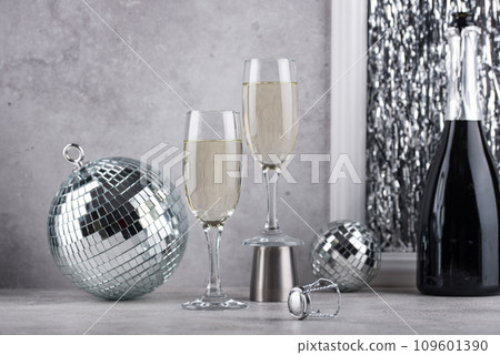 Glass of champagne with disco ball. 109601390