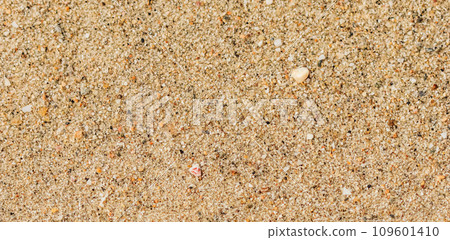 A background of sand, small pebbles and flowing waves on the sea beach. Summer vacation and coastal nature concept 109601410