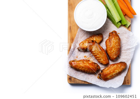 Buffalo spicy chicken wings with cayenne pepper sauce isolated on white background Buffalo spicy chicken wings with cayenne pepper sauce isolated on white background 109602451