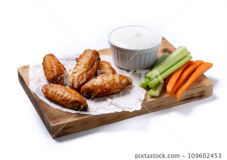 Buffalo spicy chicken wings with cayenne pepper sauce isolated on white background Buffalo spicy chicken wings with cayenne pepper sauce isolated on white background 109602453