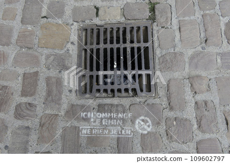 France, Colmar, manhole cover with inscription Don't throw anything away, the Rhine starts here 109602797
