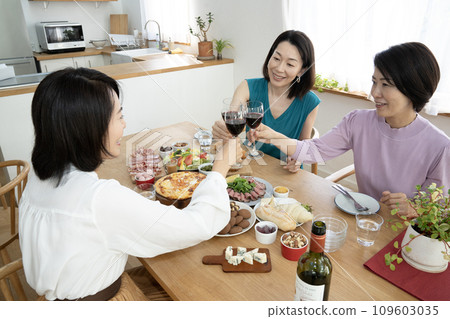 Three women toasting with wine Three women toasting with wine 109603035