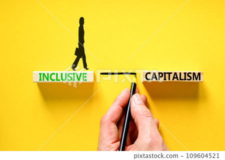 Inclusive capitalism symbol. Concept words Inclusive capitalism on beautiful wooden blocks. Businesswoman icon. Beautiful yellow table background. Business inclusive capitalism concept. Copy space. 109604521