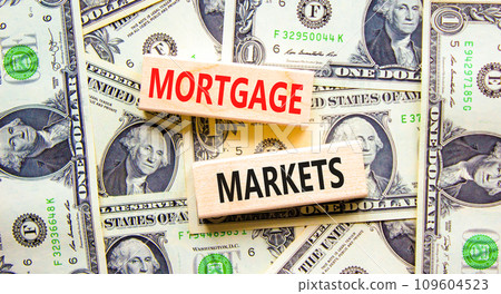 Mortgage markets symbol. Concept words Mortgage markets on beautiful wooden blocks. Dollar bills. Beautiful background from dollar bills. Business mortgage markets concept. Copy space. Mortgage markets symbol. Concept words Mortgage markets on beautiful wooden blocks. Dollar bills. Beautiful background from dollar bills. Business mortgage markets concept. Copy space. 109604523