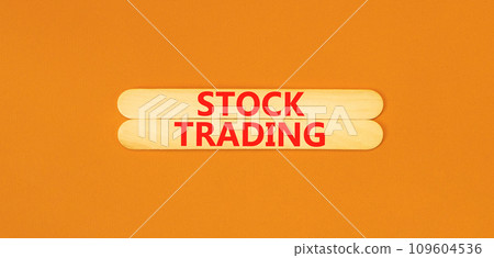 Stock trading symbol. Concept words Stock trading on beautiful wooden stick. Beautiful orange table orange background. Business stock trading concept. Copy space. Stock trading symbol. Concept words Stock trading on beautiful wooden stick. Beautiful orange table orange background. Business stock trading concept. Copy space. 109604536