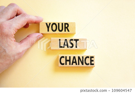 Time to your last chance symbol. Concept words Your last chance on wooden blocks on a beautiful white table white background. Businessman hand. Business and your last chance concept. Copy space. 109604547