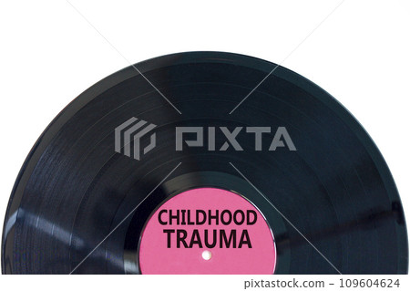 Childhood trauma symbol. Concept words Childhood trauma on beautiful black vinyl disk. Beautiful white table white background. Business psychology childhood trauma concept. Copy space. 109604624