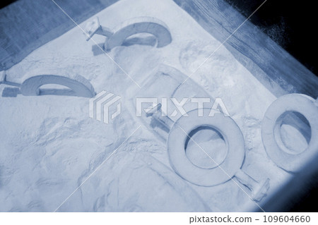 Objects printed on a 3D printer from powdered polyamide lying in white polyamide powder. Models printed on a 3D printer from powdered plastic close-up. MJF Multi Jet Fusion. 3D printing technology 109604660