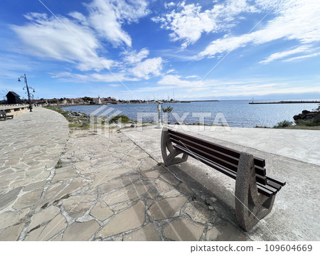 A bench and blossomed trees near the sea in Bulgaria, Nessebar A bench and blossomed trees near the sea in Bulgaria, Nessebar 109604669
