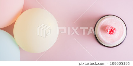 Cotton candy cake, flowers, candles and balloons for party on table top view web banner Cotton candy cake, flowers, candles and balloons for party on table top view web banner 109605395