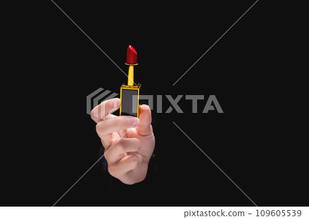 Red lipstick in a woman's hand on a dark background. Girl holding a popular cosmetic product Red lipstick in a woman's hand on a dark background. Girl holding a popular cosmetic product 109605539