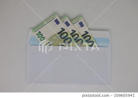 Toy house. banknotes in a yellow envelope on a light background. envelope with banknotes. close-up of an envelope with cash. international currency banknote. Euro dollars rubles. 109605941