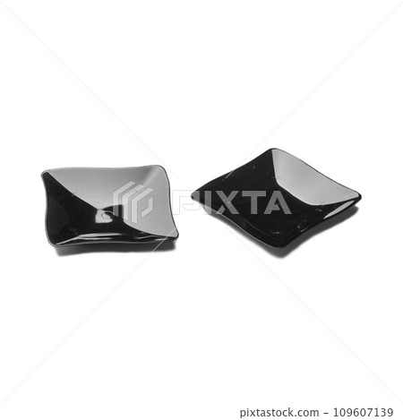 Two black plastic dessert plates isolated over white background Two black plastic dessert plates isolated over white background 109607139