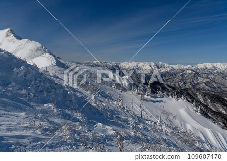 Mt. Tanigawa in winter seen from the mountain trail heading from Mt. Kengamine to Mt. Buson Mt. Tanigawa in winter seen from the mountain trail heading from Mt. Kengamine to Mt. Buson 109607470