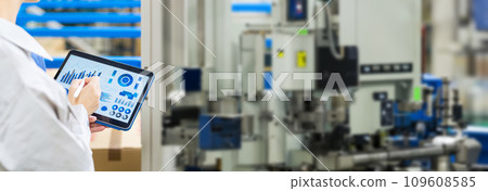 Engineer operating a machine tool with a tablet 109608585