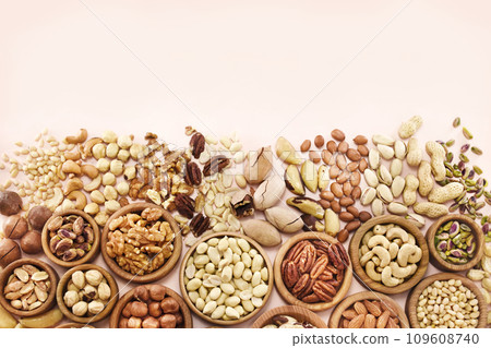 Colorful mix of various nuts: peanut and cashew, hazelnut and almond, pine nuts and walnut; healthy diet snack; vegan food background Colorful mix of various nuts: peanut and cashew, hazelnut and almond, pine nuts and walnut; healthy diet snack; vegan food background 109608740