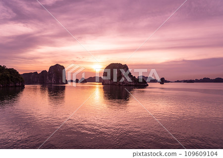 View of the sunset from the deck of a cruise ship on a cruise in Halong Bay, Vietnam View of the sunset from the deck of a cruise ship on a cruise in Halong Bay, Vietnam 109609104