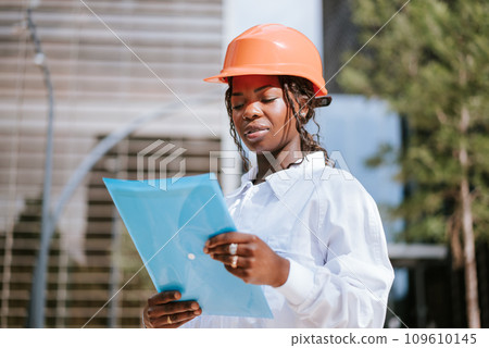 Young African American female engineer checking documents 109610145