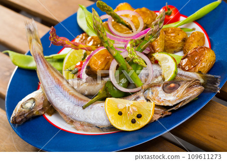 Whiting stewed in white wine with baked potatoes, fresh pea pods Whiting stewed in white wine with baked potatoes, fresh pea pods 109611273