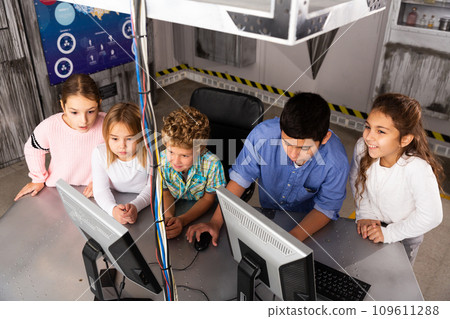Enthusiastic children play in the quest room of inscrutable bunker 109611288