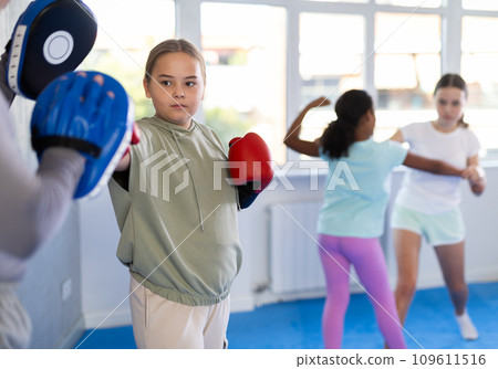 Coach and girl training boxing technique Coach and girl training boxing technique 109611516