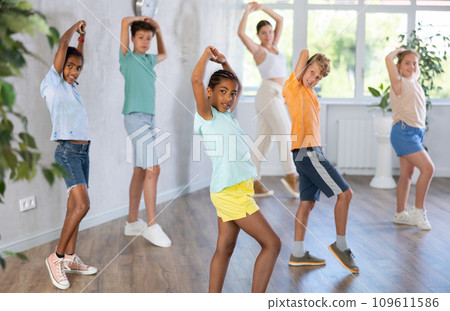 African girl perform social dance vogue with friends and female teacher in background African girl perform social dance vogue with friends and female teacher in background 109611586