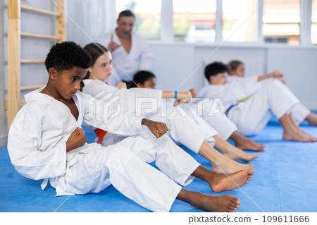 Group of children doing abdominal exercises 109611666