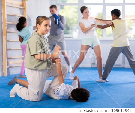 Boy and girl practicing self-defense techniques 109611945