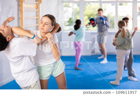 Boy and girl practicing self-defense techniques 109611957